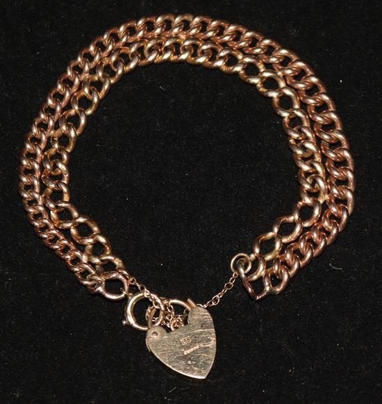 An adapted double strand 9ct gold and 15ct gold curb link bracelet with heart shaped padlock.